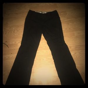 A pair of women’s black pin striped dress pants